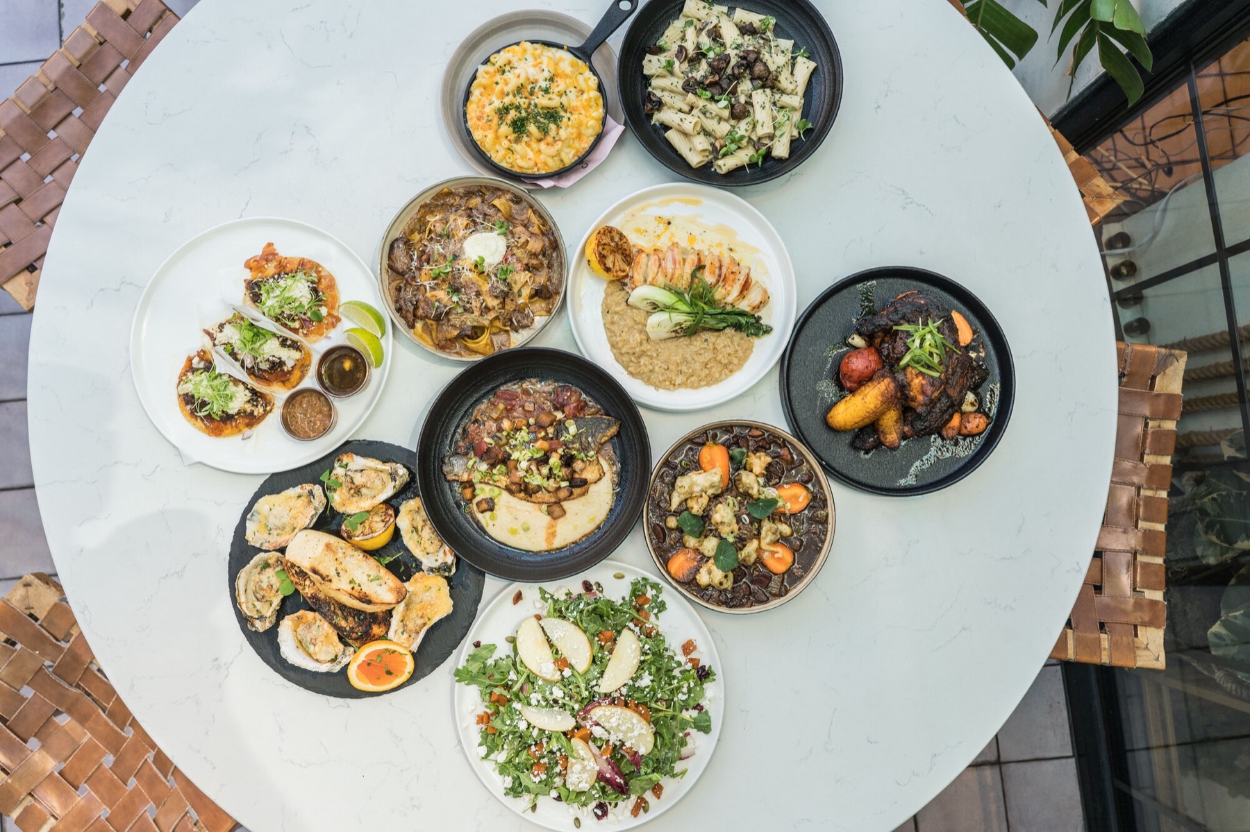 Full spread of Coco Maya dishes on the patio at Little Italy San Diego